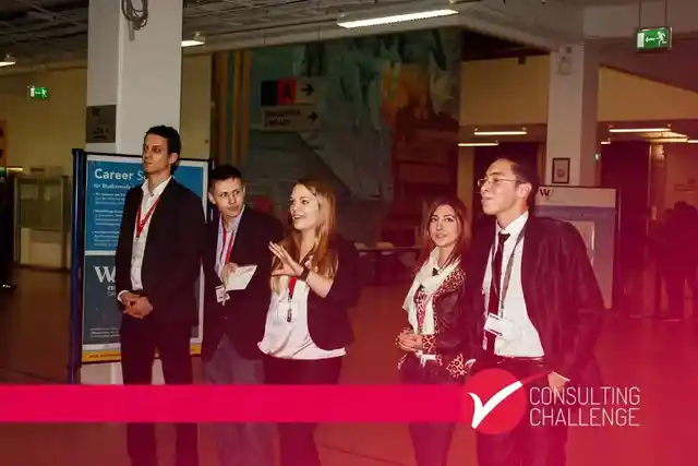 A group presenting at an event with Consulting Challenge branding.