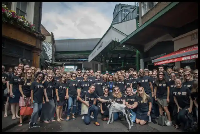 A large group posing together outside Borough Market.